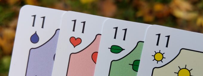 A fan of the Eleven card from each suit